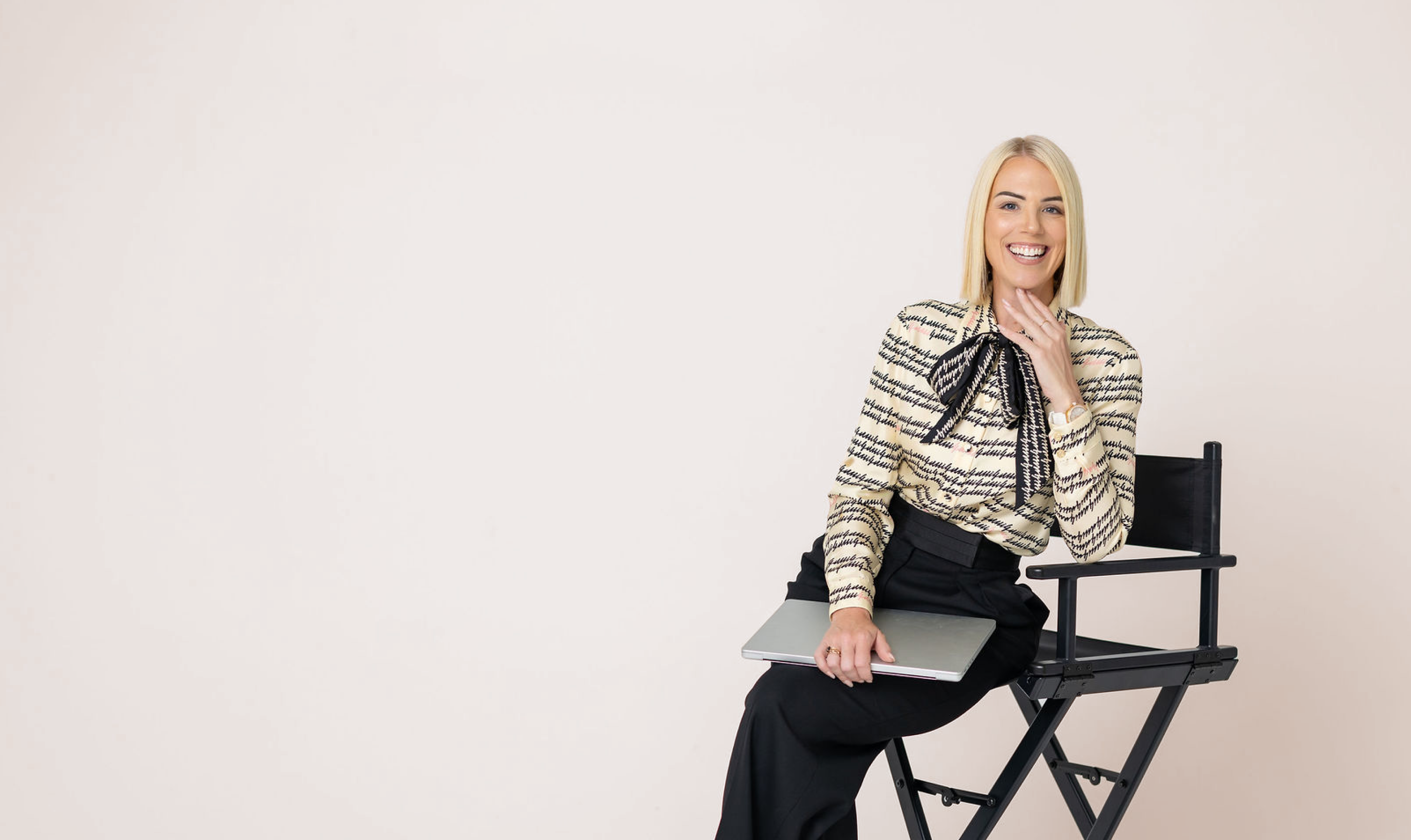 Jessica Gwynne standing in a pale studio set.